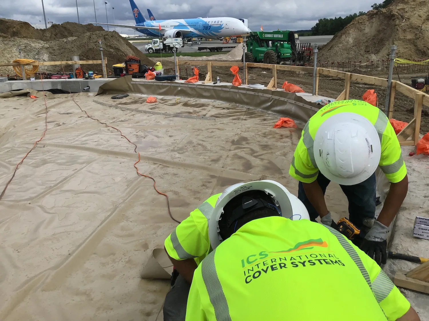 ICS geomembrane liner services header - installation crew at work