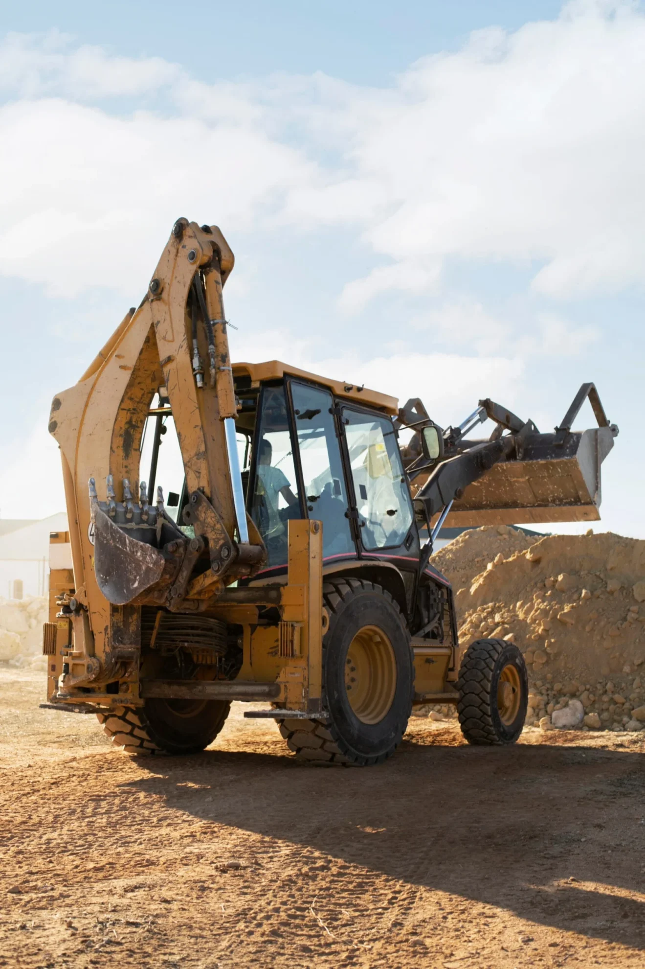 front end loader working a pile of dirt